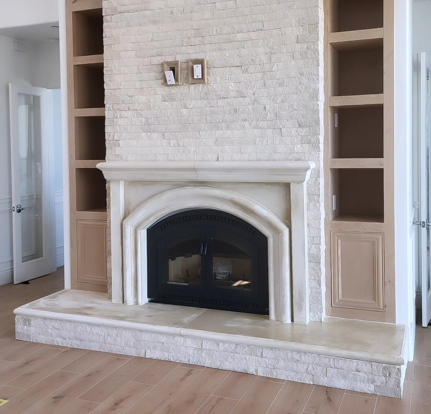 Custom architectural precast fireplace surround with arched opening installed by Lions Precast in Fresno California