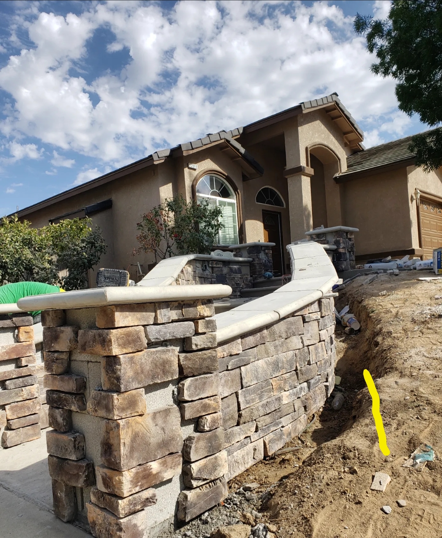 Architectural precast concrete wall caps installed on curved stone retaining wall by Lions Precast in Fresno California